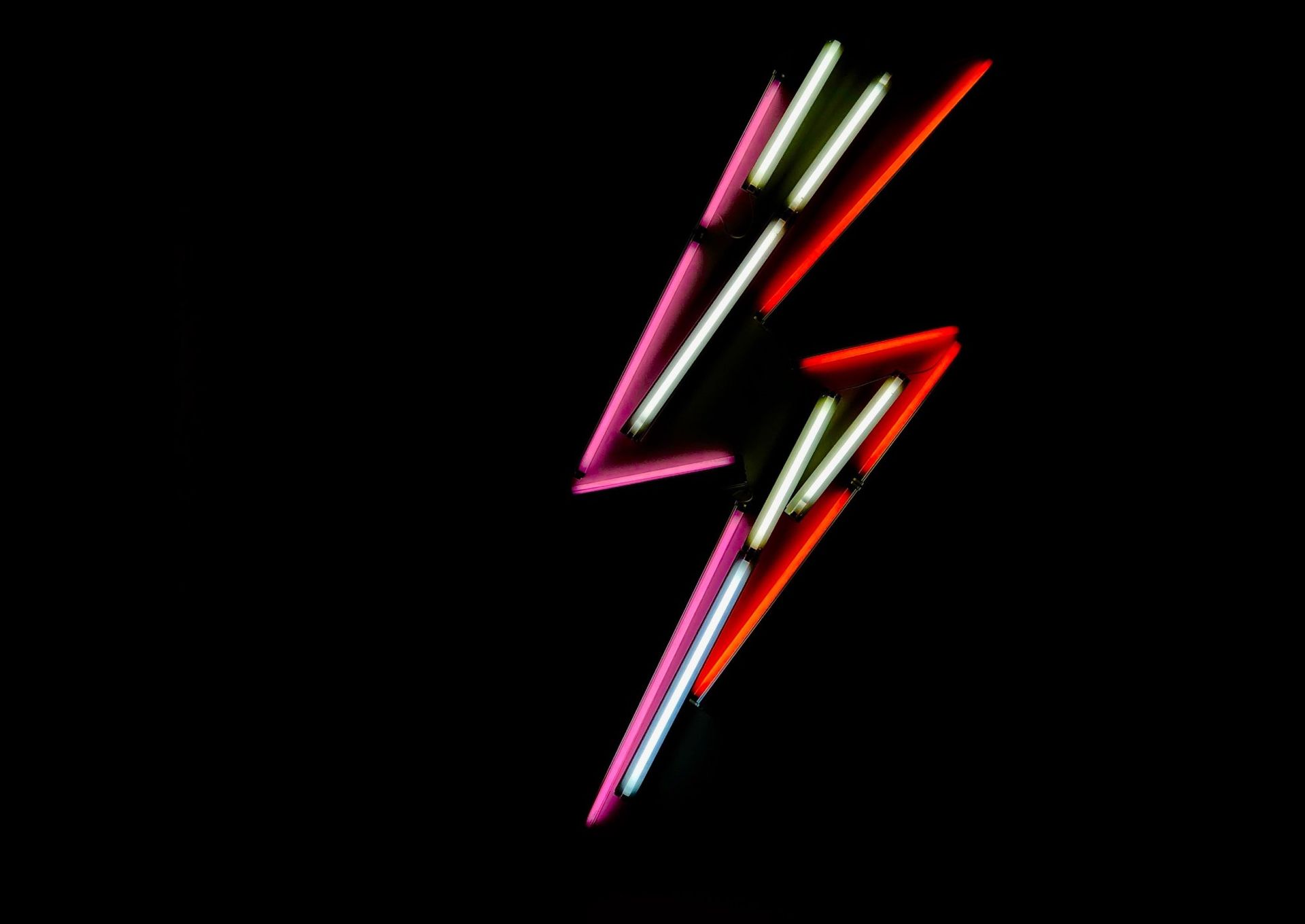 A neon lighning bolt at night