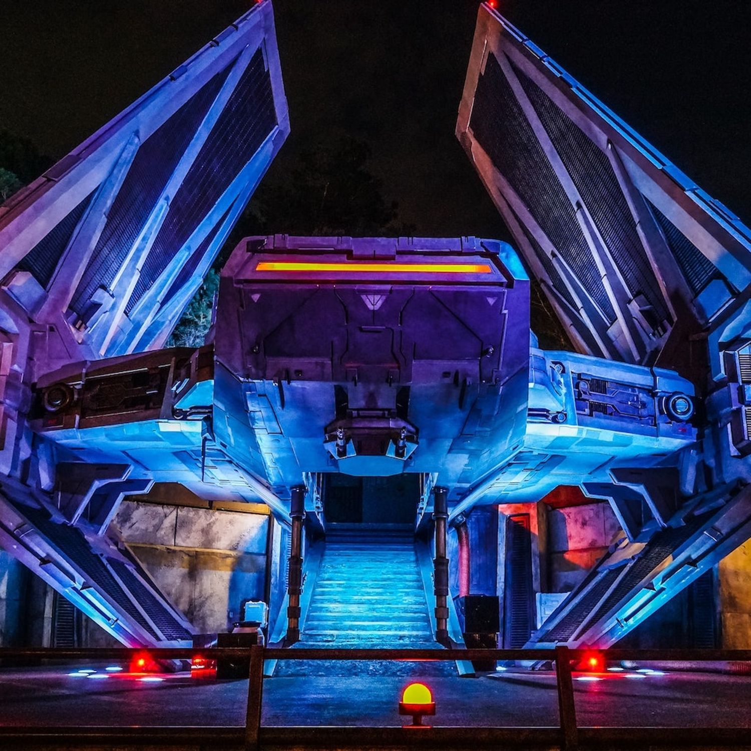 A tie fighter on a landing pad with glowing lights